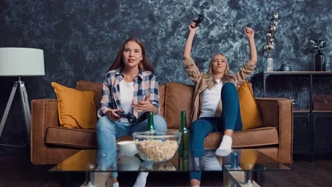 Friends Playing Console Games at Home. Friends at Couch. Gamers at Home. Girls Stock Footage 217891291