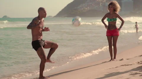 Friends playing football on Ipanema beach Stock Footage 59377049