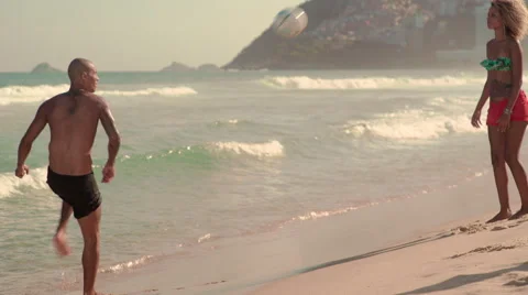 Friends playing football on Ipanema beach Stock Footage 59377050