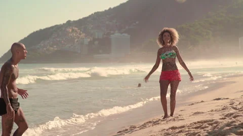 Friends playing football on Ipanema beach Stock Footage 59377114