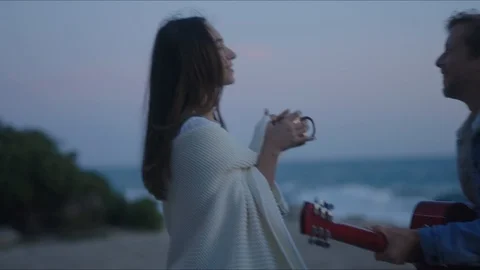 Friends playing guitar and dancing, chill evening at west coast of California Stock Footage 127409317
