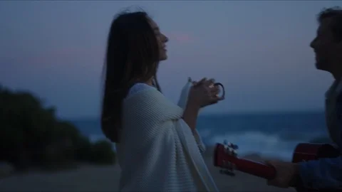 Friends playing guitar and dancing, chill evening at west coast of California Stock Footage 127409644