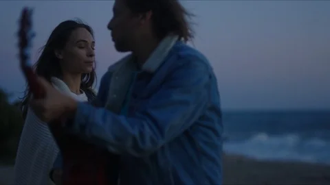 Friends playing guitar and dancing, chill evening at west coast of California Stock Footage 127409656