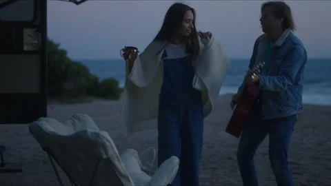 Friends playing guitar and dancing, chill evening at west coast of California Stock Footage 127409674