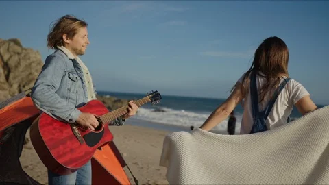Friends playing guitar and dancing at west coast of California Stock-Footage 127409917