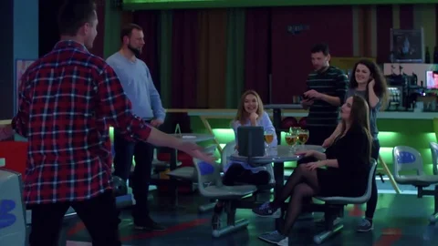 Friends playing having fun at bowling HD slow-motion video. Man woman at table Stock Footage 72219751
