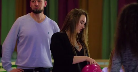 Friends playing having fun bowling 4k video. Man woman prepares for bowl game Stock Footage 72220075