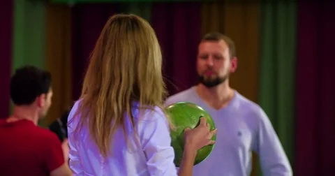 Friends playing having fun at bowling 4k video. Woman holds ball Stock Footage 72220147