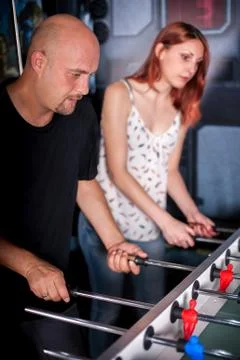Friends playing table foosball Stock Photos