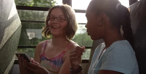 Friends playing tablet game on school bus Stock Footage 53401155