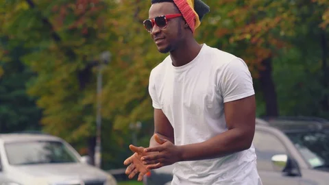 Friends playing thrwing ball to eathother utdoors campus park Stock Footage 130051963