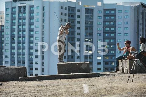 Friends playing urban golf in the city Stock Photos