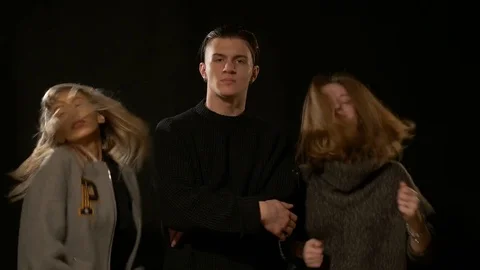 Friends posing in the studio on a black background Stock Footage 72289430