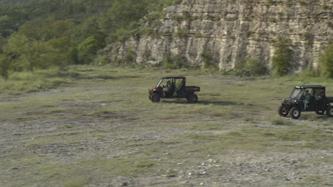 Friends Race ATVs in the Wilderness Stock Footage 323403606