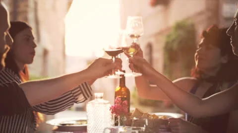 Friends raising wine glasses to make a toast Stock Footage