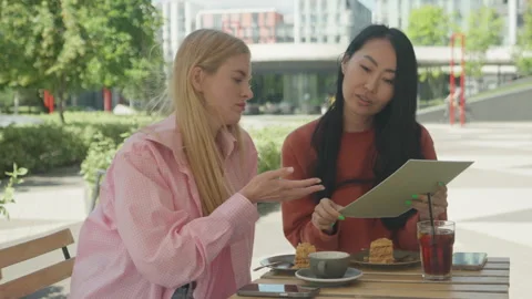 Friends Reading Cafe Menu Together At Modern Outdoor Terrace Stock Footage 313843320