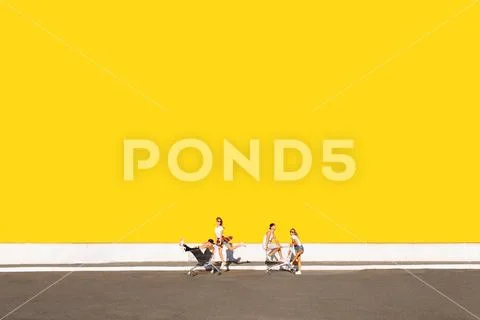 Friends ride on carts, near the supermarket, a great pastime, a group of youn Stock Photos