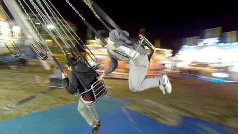 Friends riding the chairoplane carousel Stock-Footage 86661270
