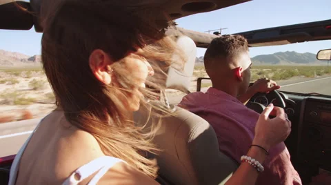 Friends On Road Trip Driving In Convertible Car Shot On R3D Stock Footage