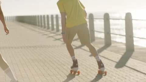 Friends rollerskating on the broadwalk Stock Footage 279343593