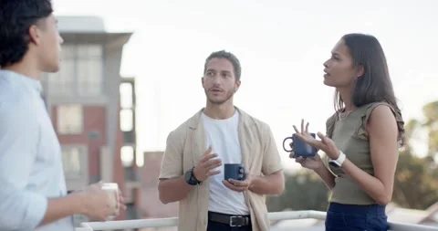 Friends on rooftop railing, left Asian man starting chat holding glass, others Stock Footage 339983547