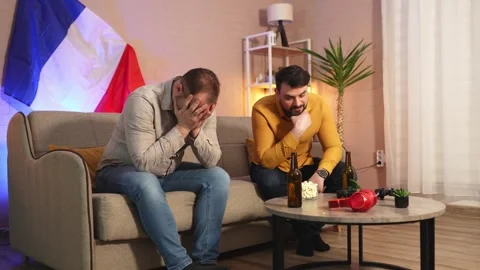 Friends share a tense evening while watching a sports event at home Stock Footage 305952336