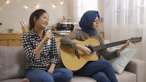 Friends in shared apartment playing guitar sing Stock Footage 109109676