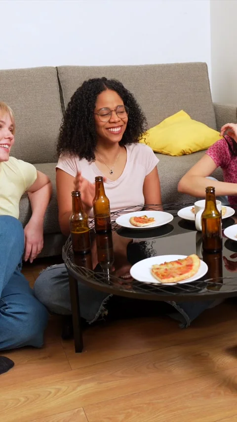 Friends sharing laughter, pizza, and beer at home Stock Footage 306216426