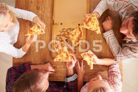 Friends sharing a pizza together, overhead view Stock Photos