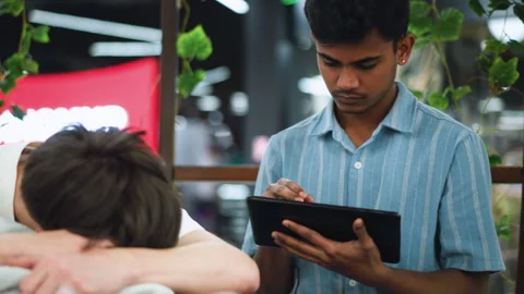 Friends sharing quiet Ipad and nap moment Stock Footage 318261966
