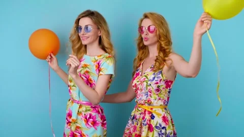 Friends sister dancing having fun, fashionable woman in floral dress with balloo Video stock 246547989