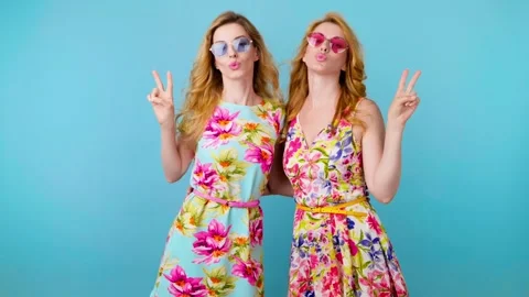 Friends sister dancing having fun, fashionable woman in floral dress excited rhy Stock Footage 256311393