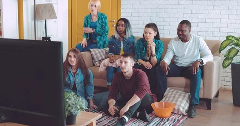 Friends sit and watch with great interest the match on TV, are very worried Video stock 88658341
