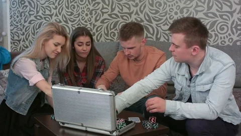 Friends sit on a sofa and play the game Stock-Footage 73477655