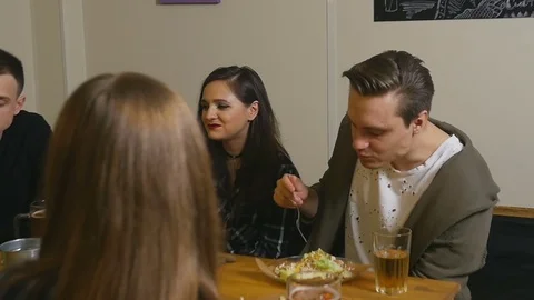 Friends sit at a table in a cafe Stock Footage 77378471