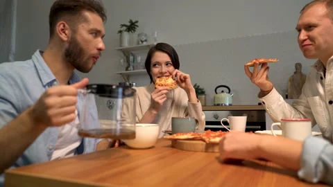 Friends sit at a table at home, drink coffee or tea, spend their free time Video stock 167648074