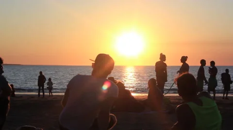 Friends sitting on a beach Stock Footage