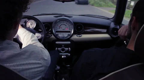 Friends sitting in car, driving down the street Stock Footage 41498751