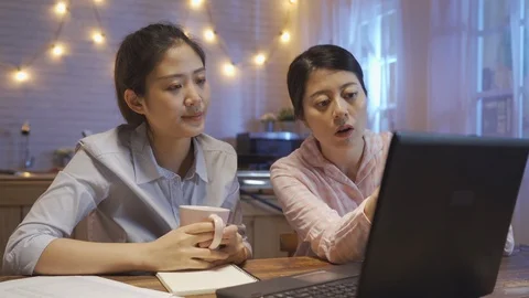 Friends sitting at kitchen discussing about work Video stock 107264464