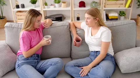 Friends sitting on sofa and talking Video stock 247114321