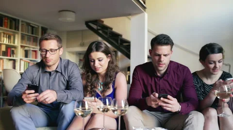 Friends sitting on the sofa and using smartphones, steadycam shot Stock-Footage 53851776