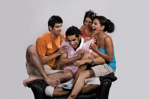Friends sitting on a sofa Stock Photos