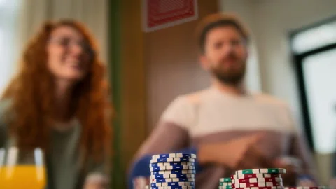Friends sitting at table indoors and playing card games, laughing and smiling Stock Footage 267681663