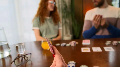 Friends sitting at table indoors and playing card games, laughing and smiling Stock Footage 267682003