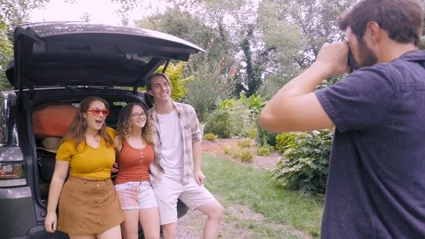 Friends smiling and getting ready for a road trip get their photo taken Video stock 120639322