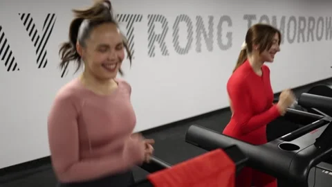 Friends smiling during treadmill run Stock Footage 337115006