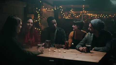 Friends smiling while having a toast with craft beers at the bar Stock Footage 132014145