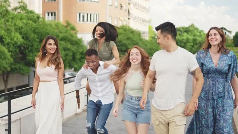 Friends smiling while running playfully Stock Footage 201047002