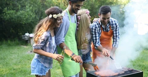 Friends spending time in nature and having barbecue Stock Footage