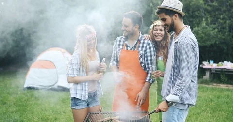 Friends spending time in nature and having barbecue Stock Footage